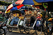 Riding the becak, the local cycle rickshaws in Malioboro street Yogyakarta. 